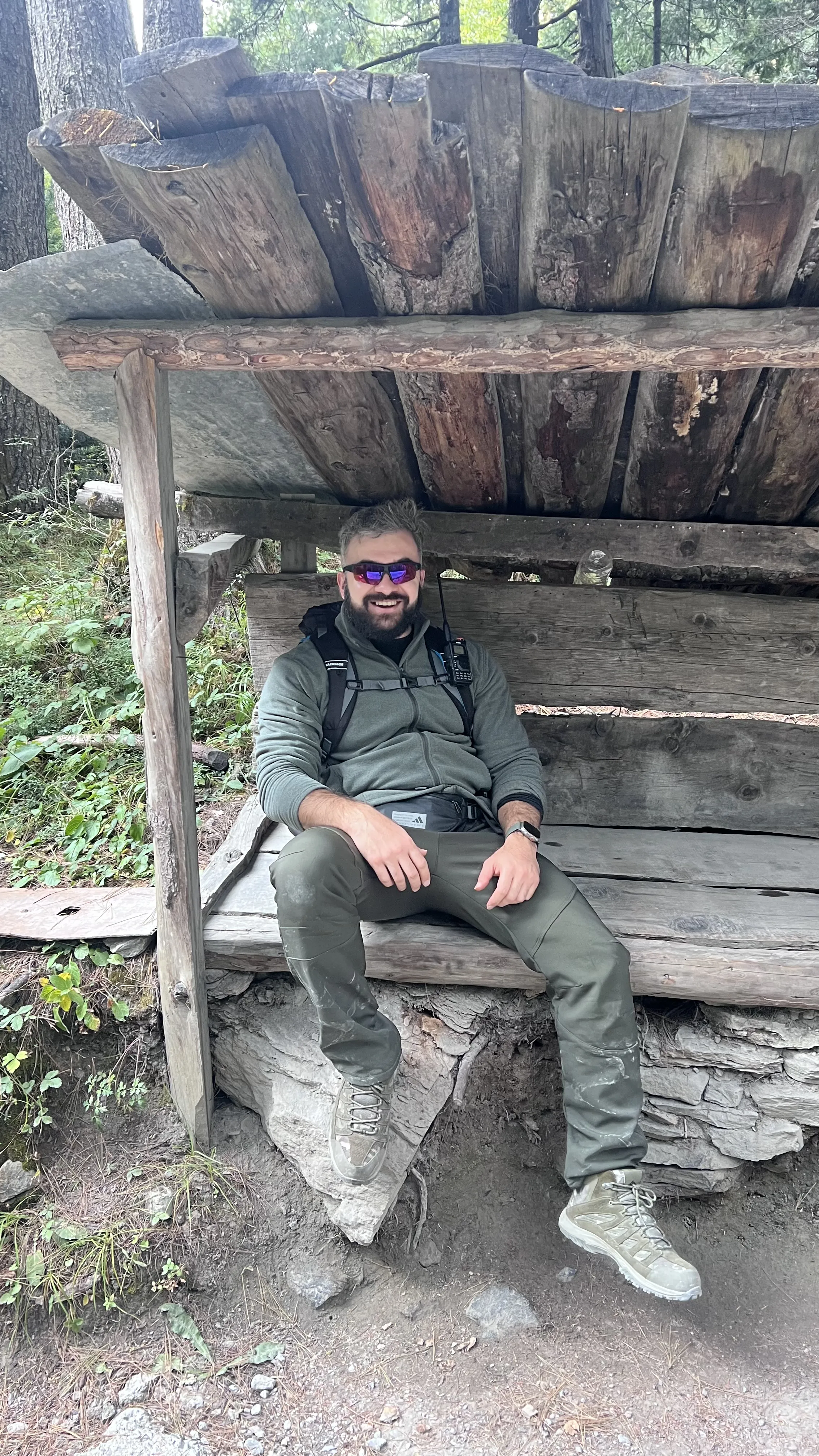 Ian Gabaraev resting on a rustic wooden bench along the Annapurna Circuit trail